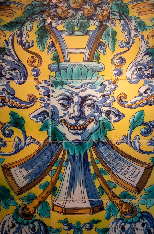 Free Ornate ceramic tile artwork featuring a mythological face surrounded by vibrant patterns. Stock Photo