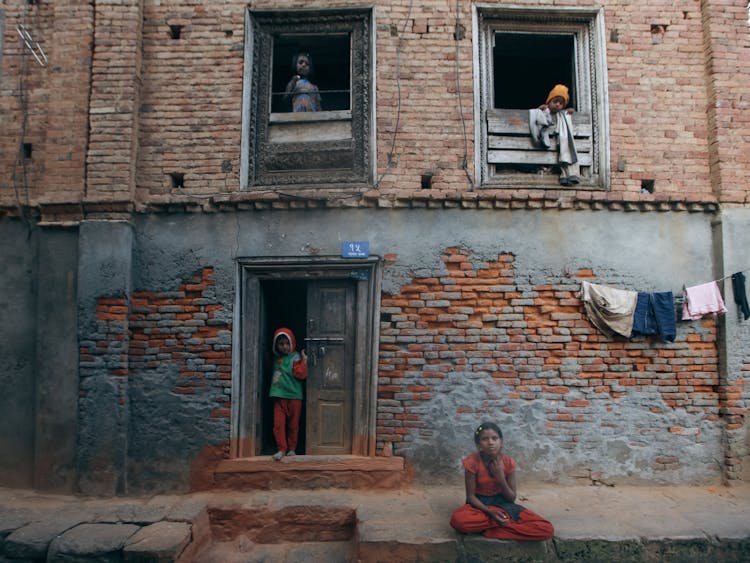 Children Near And In Damaged Building