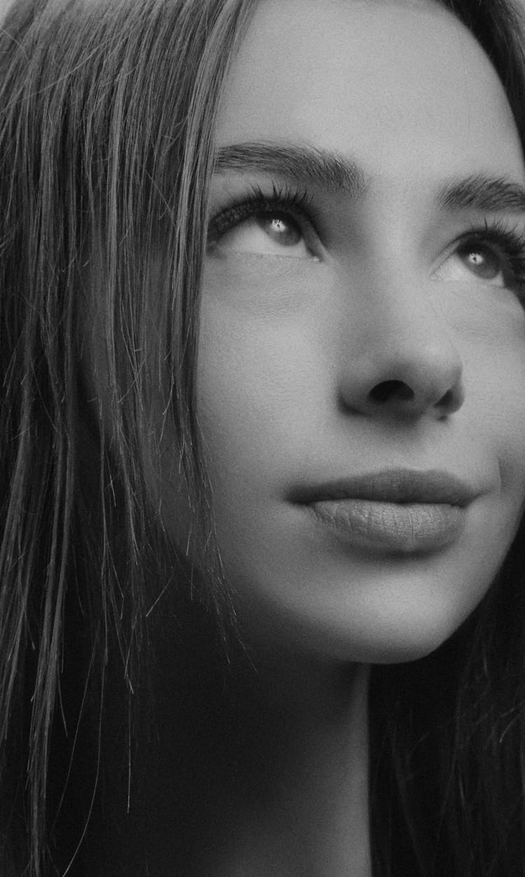 Grayscale Portrait Of A Woman Looking Up