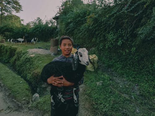 Boy Holding Goat Kid