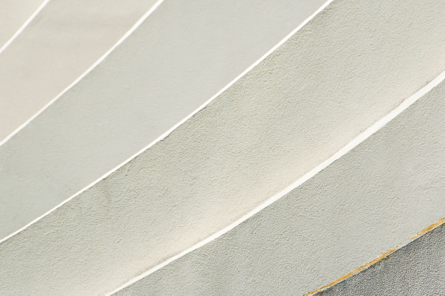Abstract close-up image of curved textured wall with neutral tones.