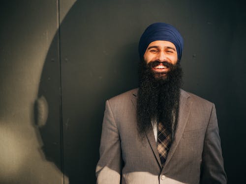 Happy Man Leaning on Black Wall