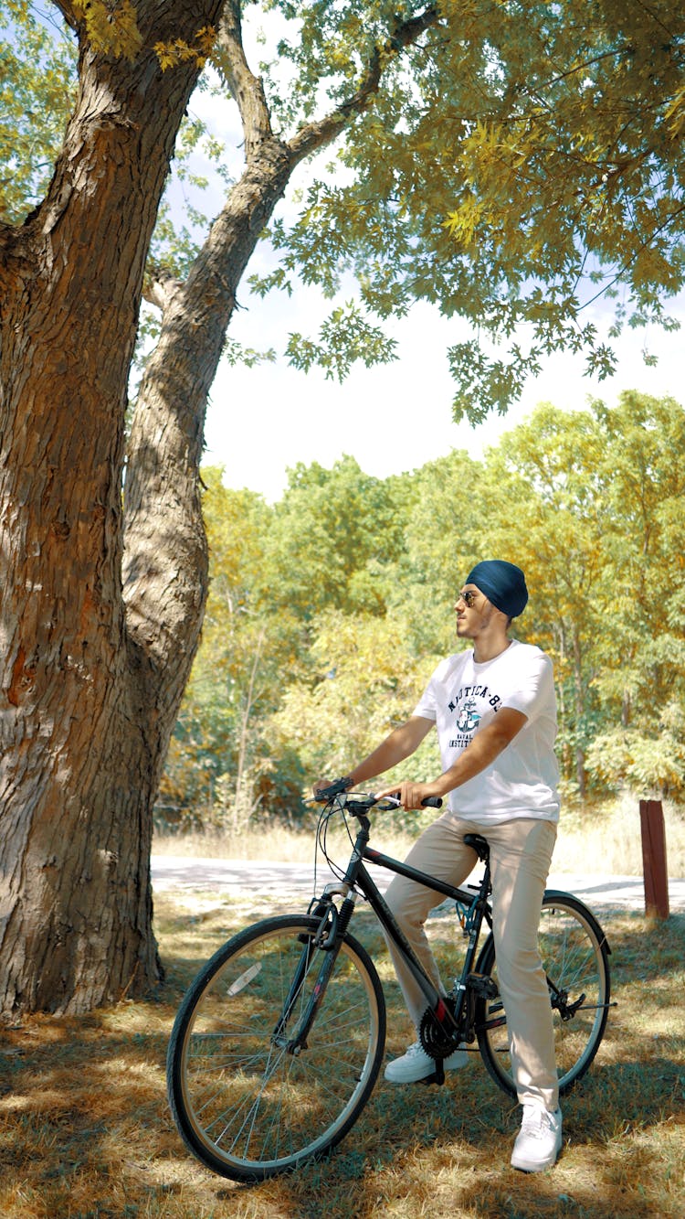 Man Riding A Bicycle Near The Tree