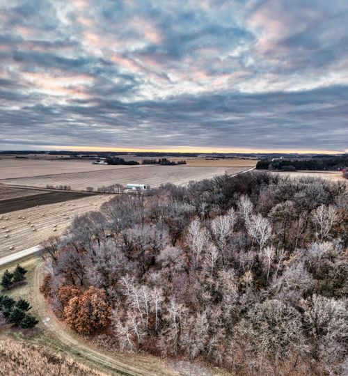 Free Captivating aerial shot of rural Elgin, Minnesota with fields and trees under a cloudy sky. Stock Photo