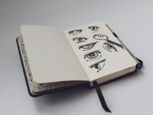 Open sketchbook filled with ink studies. Photo by ckeletn on Pexels