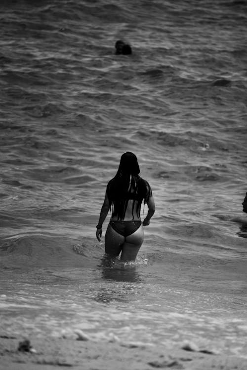 Grayscale Photo of Woman Wearing Bikini on the Sea