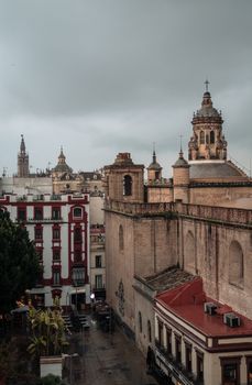 Drone shot of Seville Cathedral's ornate architecture on a cloudy day.