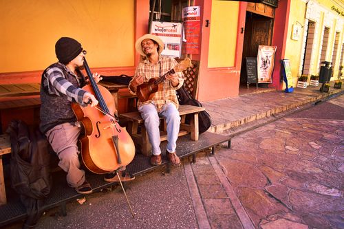 Free Two street musicians playing cello and guitar in San Cristóbal de las Casas. Stock Photo