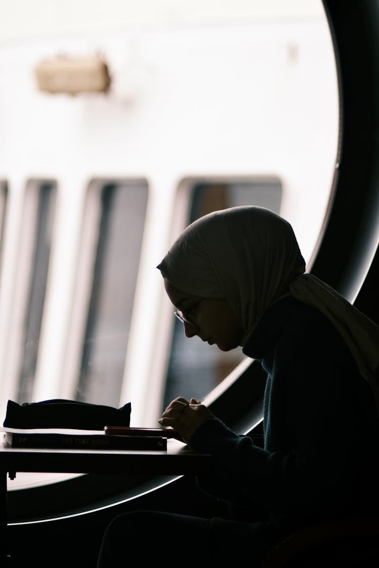 Silhouette Of A Woman Using A Phone