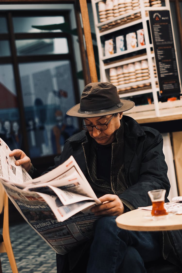 A Man Reading A Newspaper 