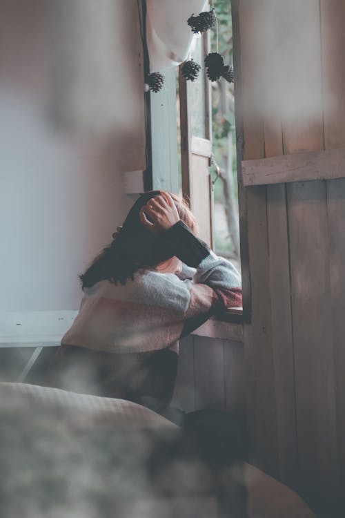 Free Photo of a Person Leaning on Wooden Window Stock Photo