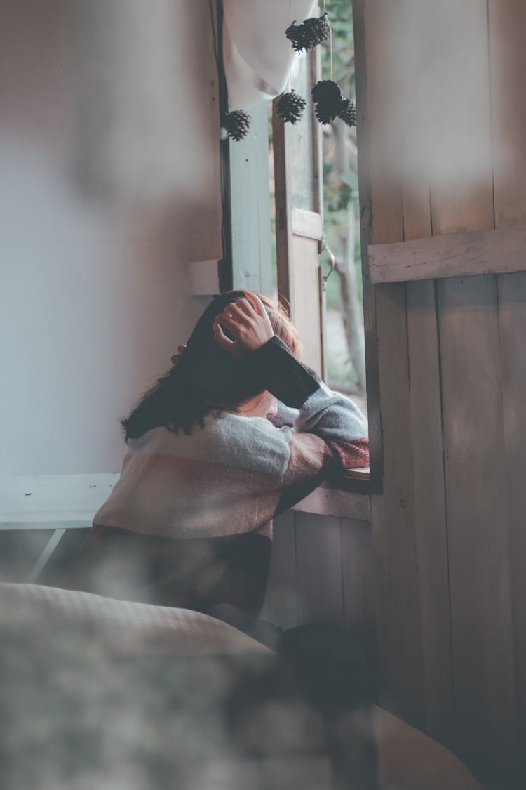 Photo Of A Person Leaning On Wooden Window