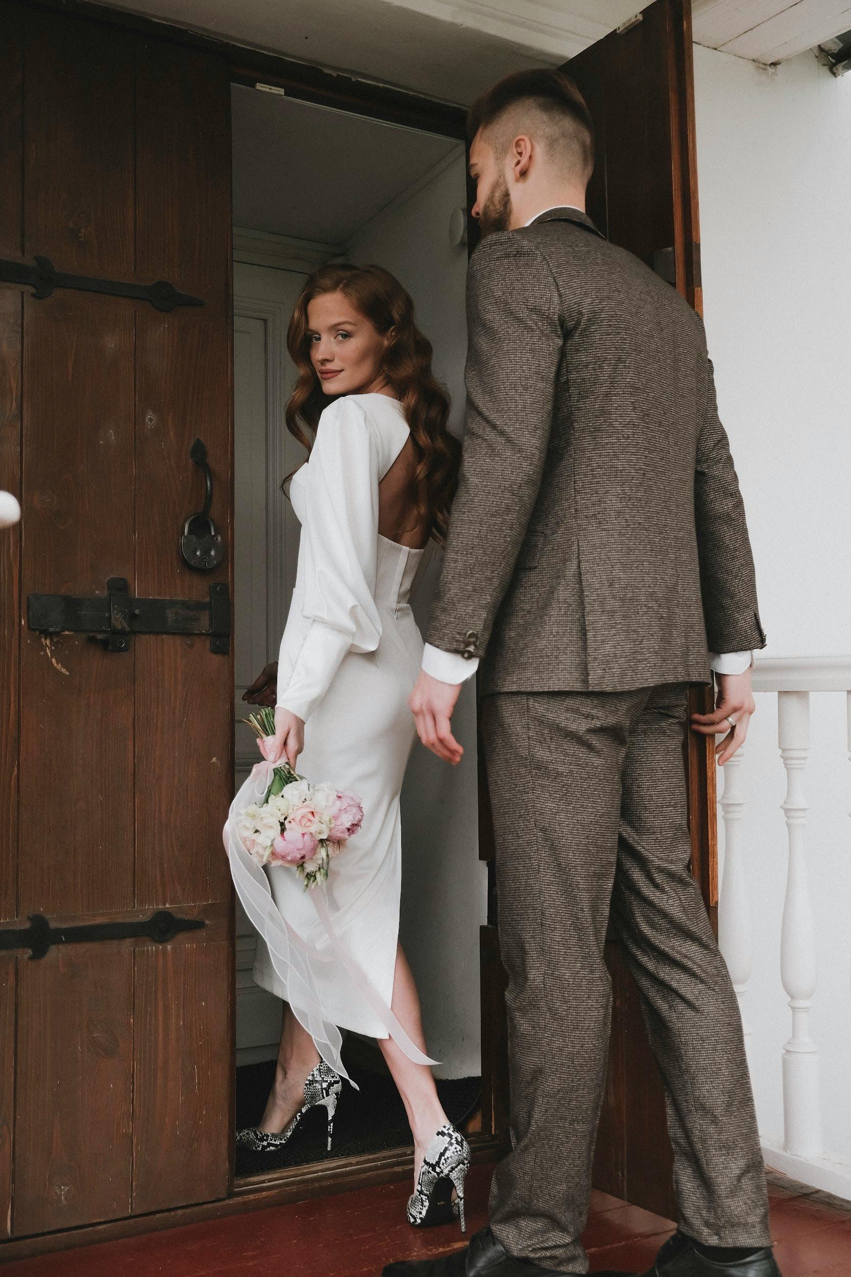 bride and groom walking through the door