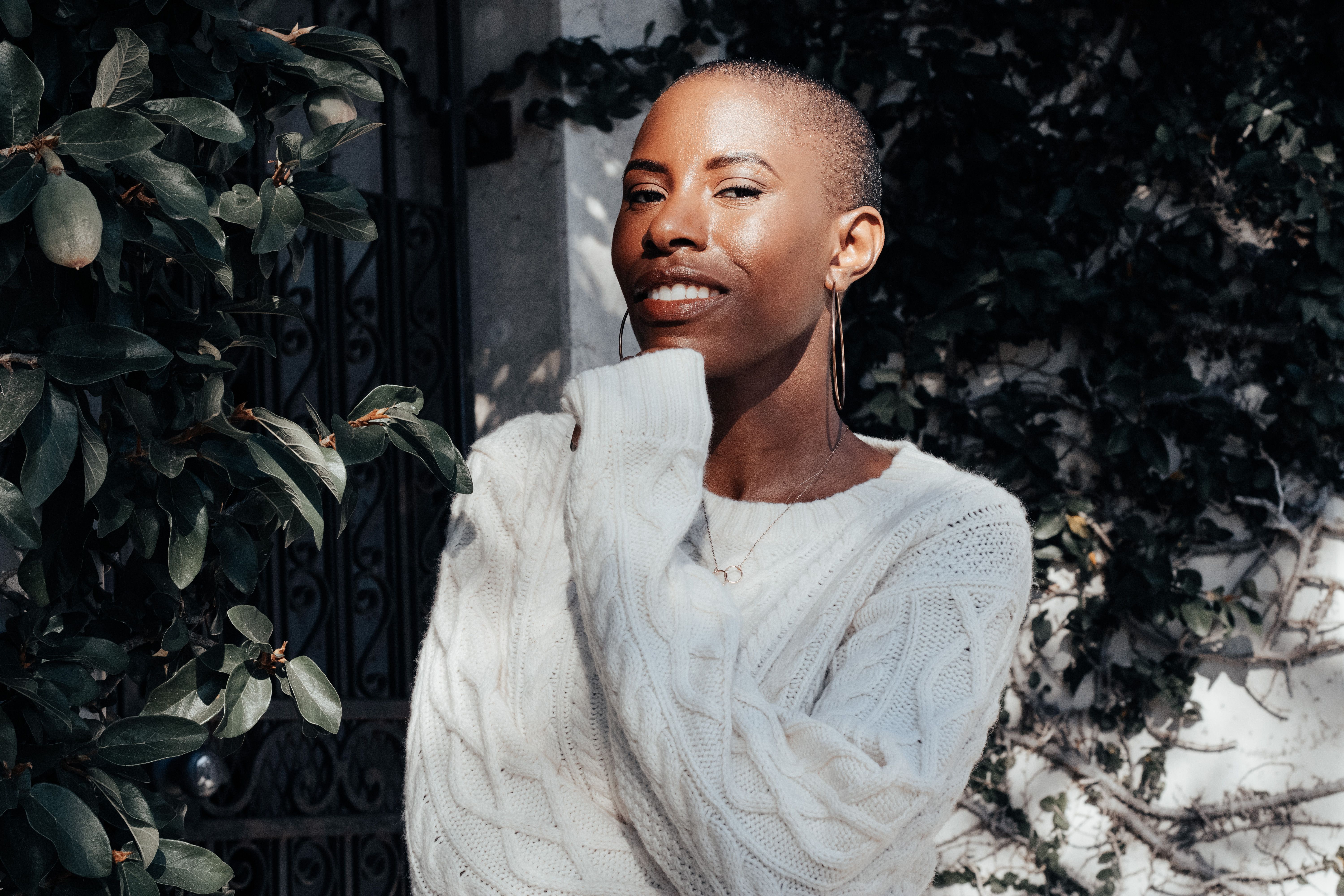 Young Woman Posing Outdoors in Sunlight · Free Stock Photo