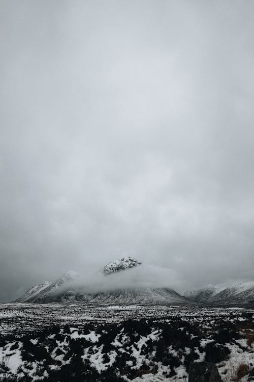 Snow Covered Mountain Covered with Clouds