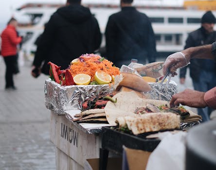 Close-up of a street food vendor preparing delicious grilled wraps with colorful vegetables and spices.