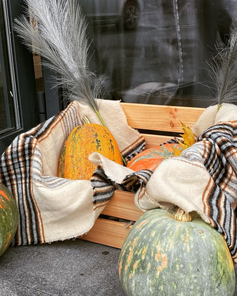 Rustic fall pumpkin display with plaid blanket