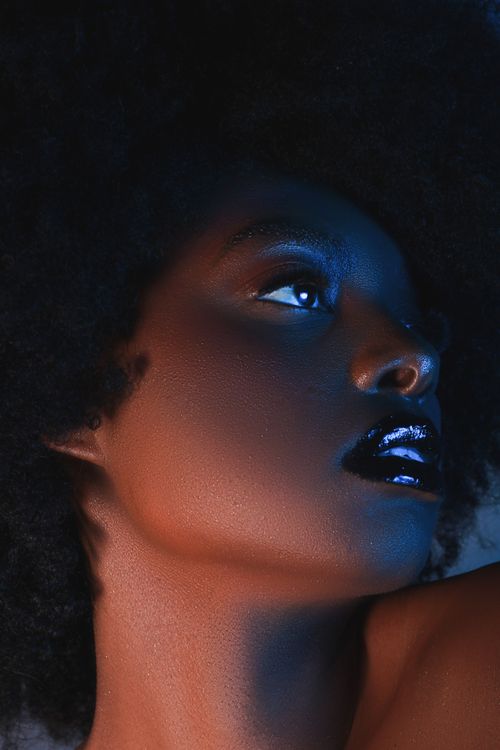 Free Close-up shot of a beautiful African American woman with striking makeup and lighting. Stock Photo
