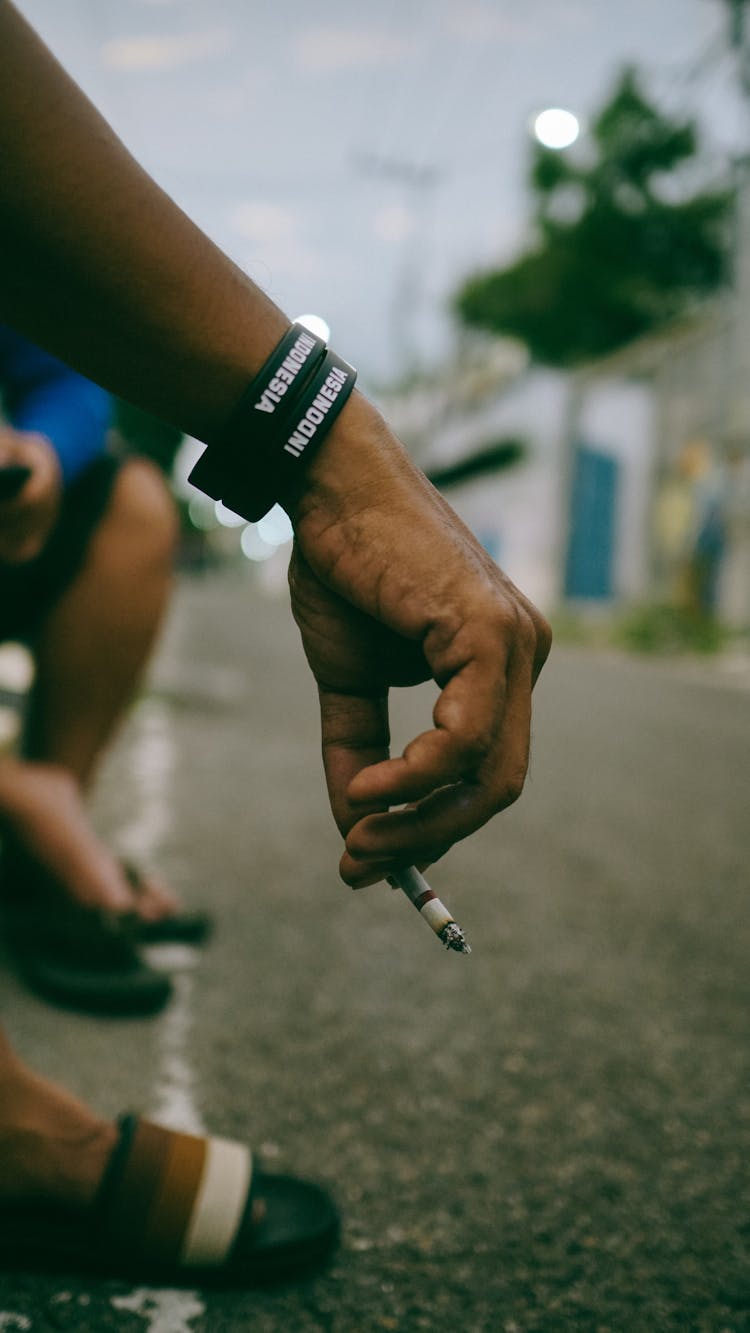 A Person Smoking A Cigarette