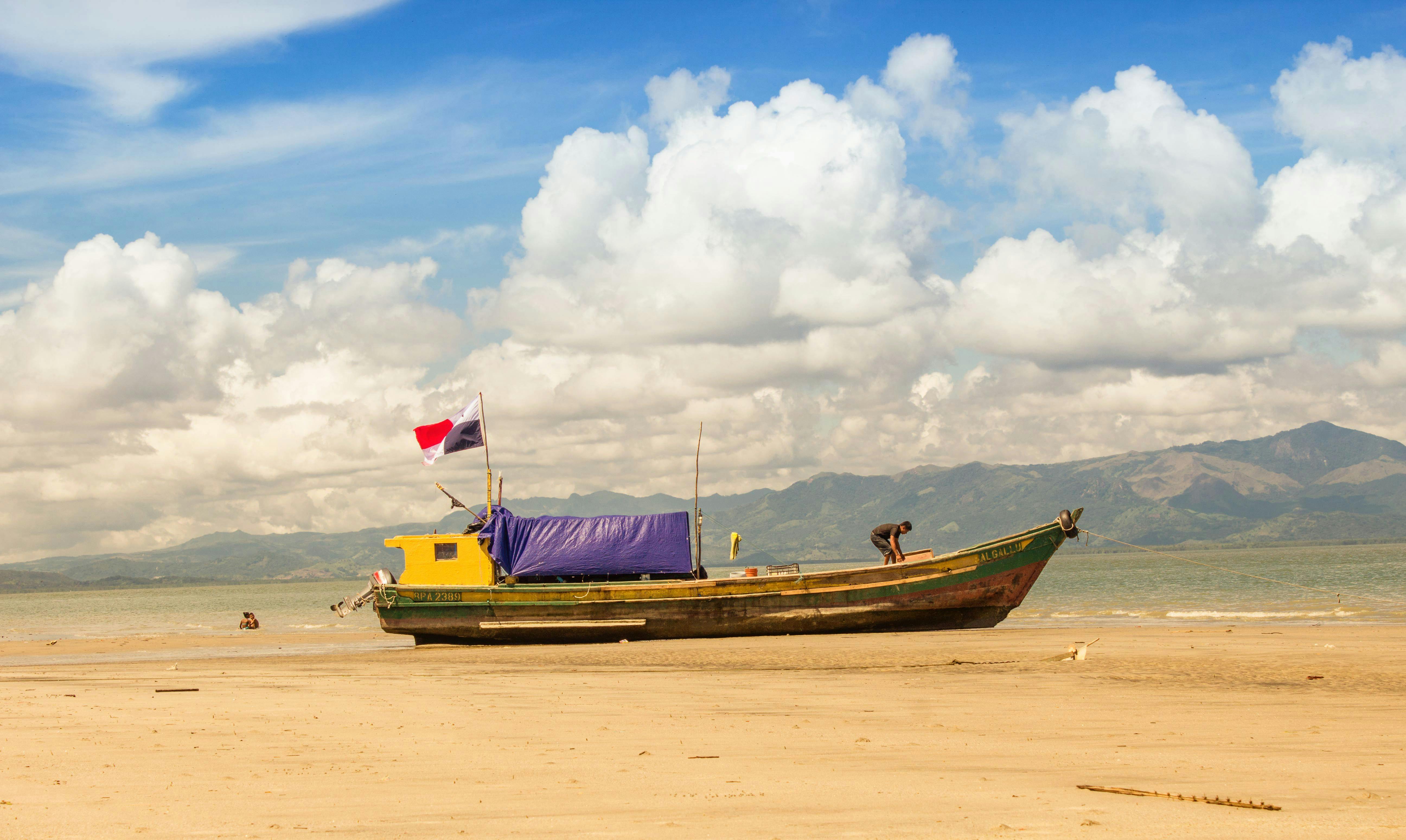 A vibrant fishing boat rests on the sandy shores of Punta Chame, Panama — the Pacific peninsula an hour west of Panama City that anchors Coronado's regional identity.