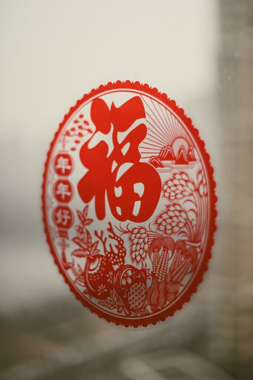 Free Close-up of a red Chinese sticker on a window symbolizing luck and prosperity. Stock Photo