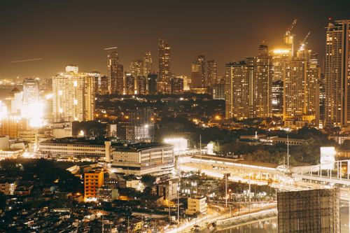 Free A vibrant night skyline captured from above, showcasing illuminated skyscrapers and urban landscape. Stock Photo