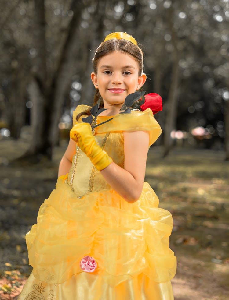 A Young Girl Wearing A Disney Princess Costume