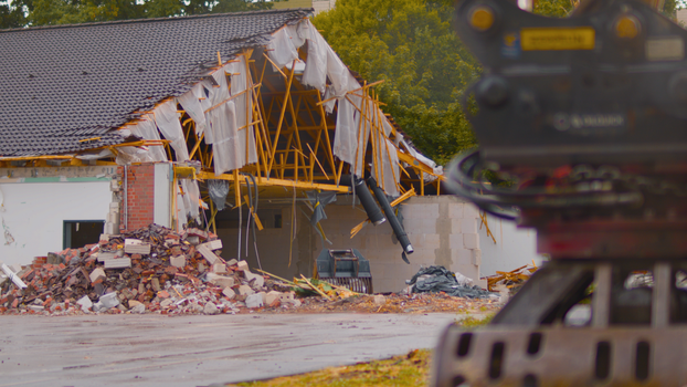 Demolition site of a building with rubble and construction machinery in Essen, Germany.