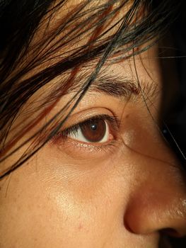 Detailed close-up photo of a person's eye and surrounding skin, emphasizing texture and natural features.