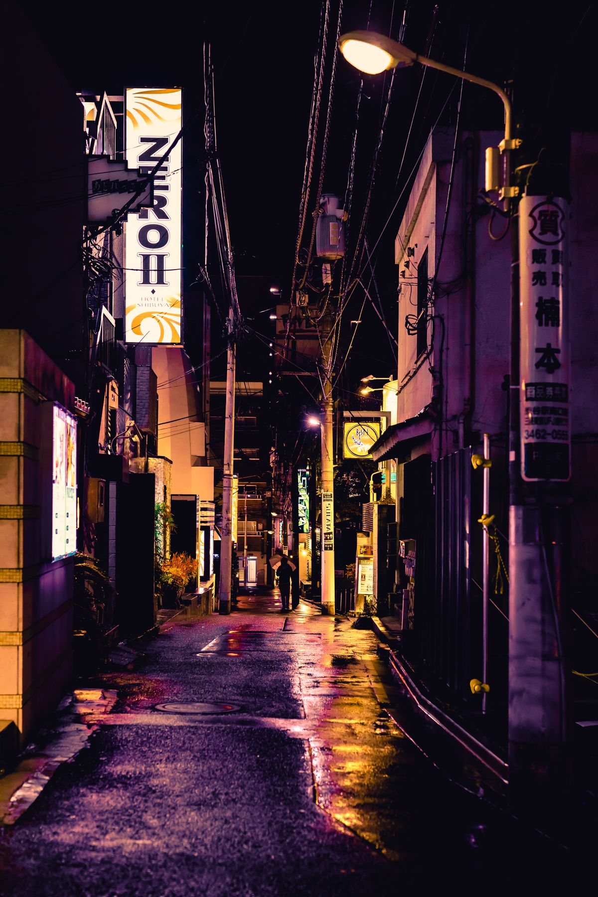 Tokyo skyline at night with illuminated buildings reflecting city lights