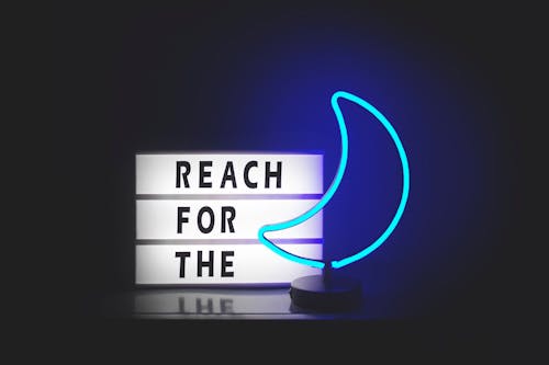 Free Reach for the and Blue Moon Neon Signages Stock Photo