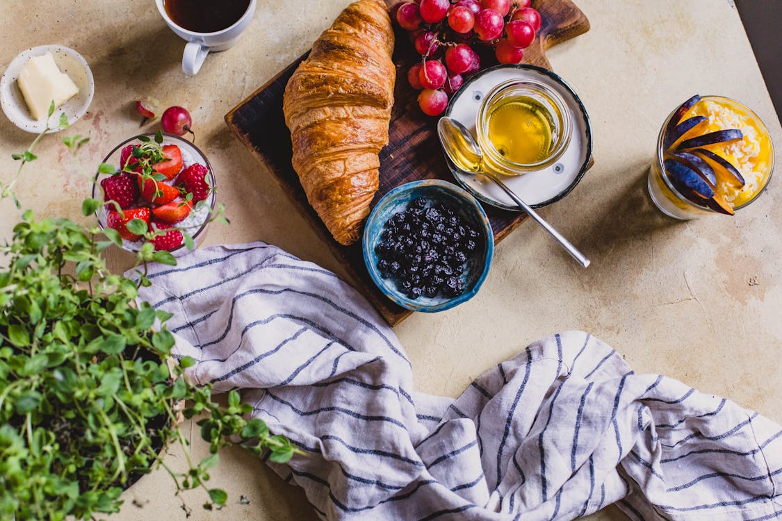 Free Croissant Bread On Table Beside Berries Stock Photo