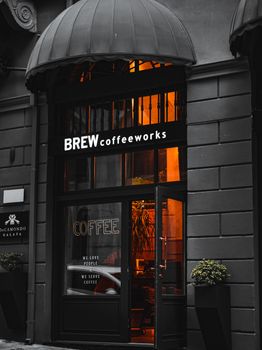 Elegant coffee shop entrance with warm lighting and inviting atmosphere.