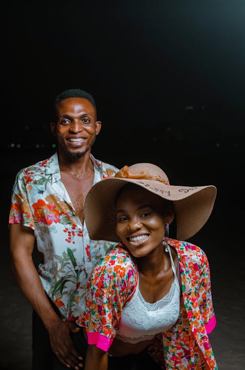 Smiling Couple Posing in Floral Print Shirts