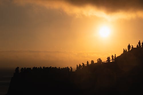People in Mountains at Golden Sunset