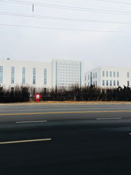 Contemporary white building in urban setting, showcasing modern minimalist architecture.