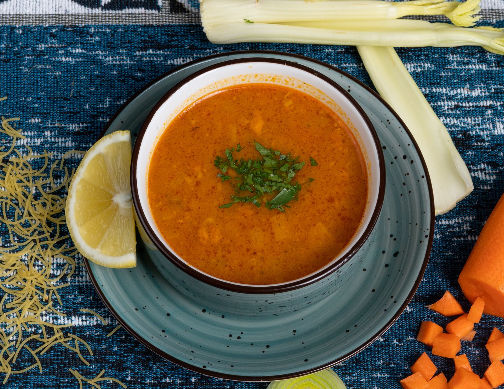 Bowl of creamy vegetable soup with fresh herbs garnish