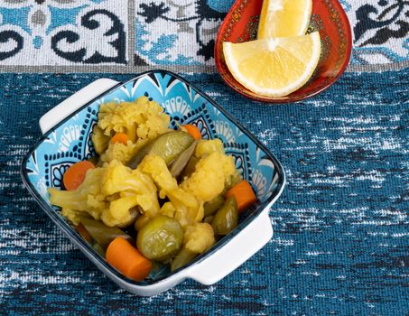 A vibrant vegetable medley in a stylish dish on a decorative table setting, perfect for a healthy meal.
