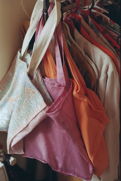 Close-up of a Clothing Rack with Hanging Clothes and Bags 