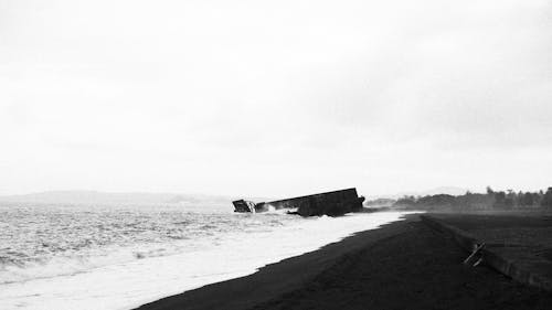 Grayscale Photo of a Shipwreck on Sea