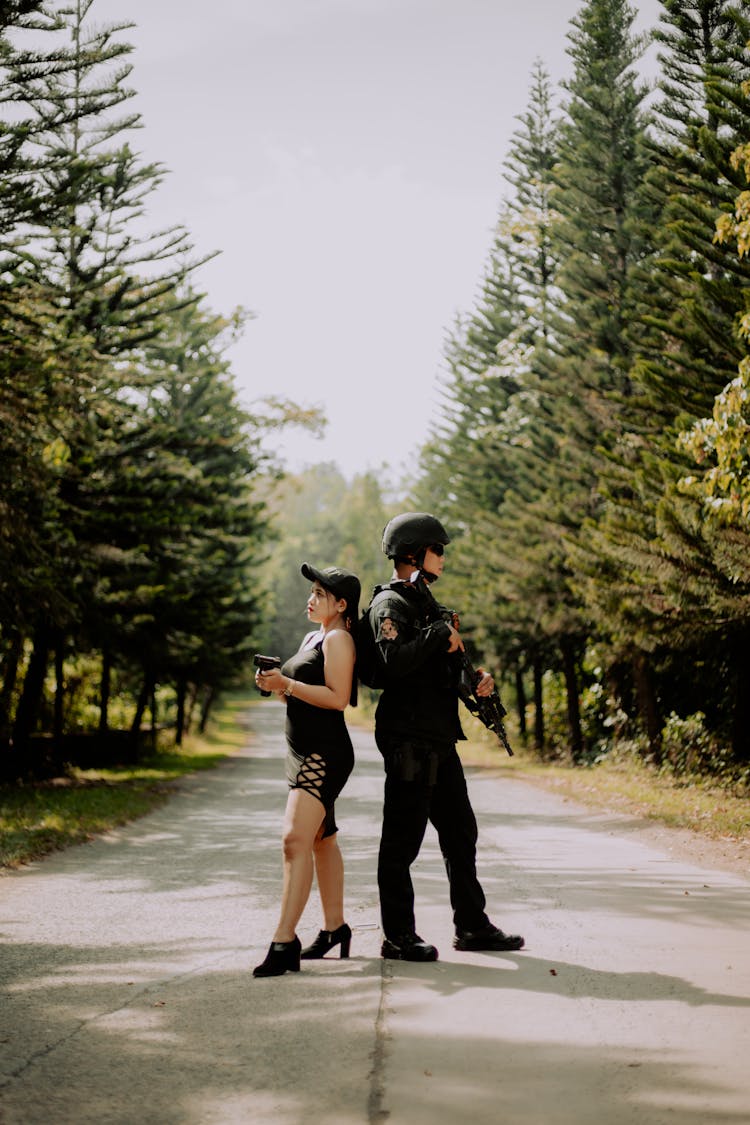 Armed Man And Woman In The Middle Of The Road