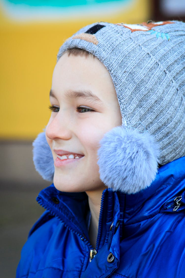 Portrait Of Smiling Kid In Knitted Hat