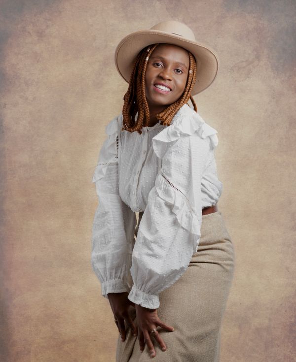 A woman in a dress and hat is posing · Free Stock Photo