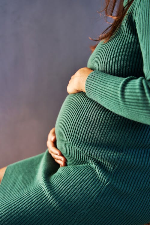 Free Woman Holding Her Baby Bump Stock Photo