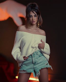 Portrait of a fashionable woman in a cozy sweater and denim shorts.