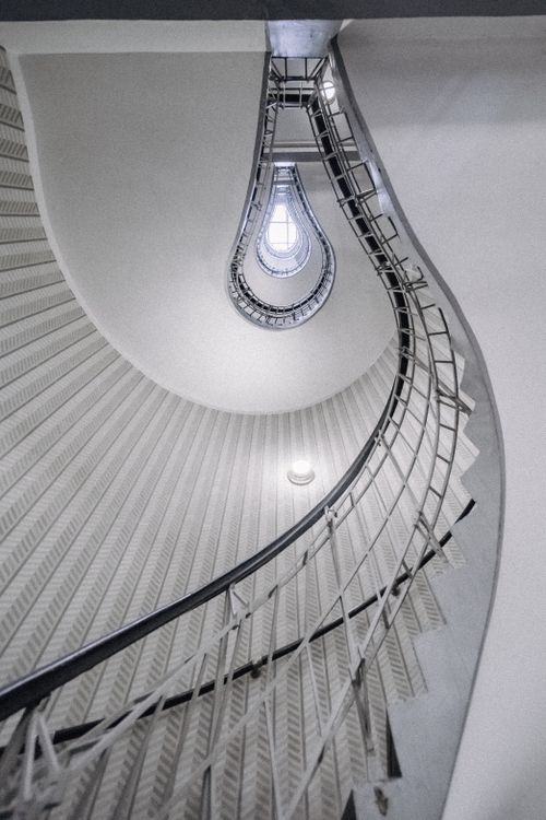 Free A stunning vertical view of a modern spiral staircase with a captivating design. Stock Photo