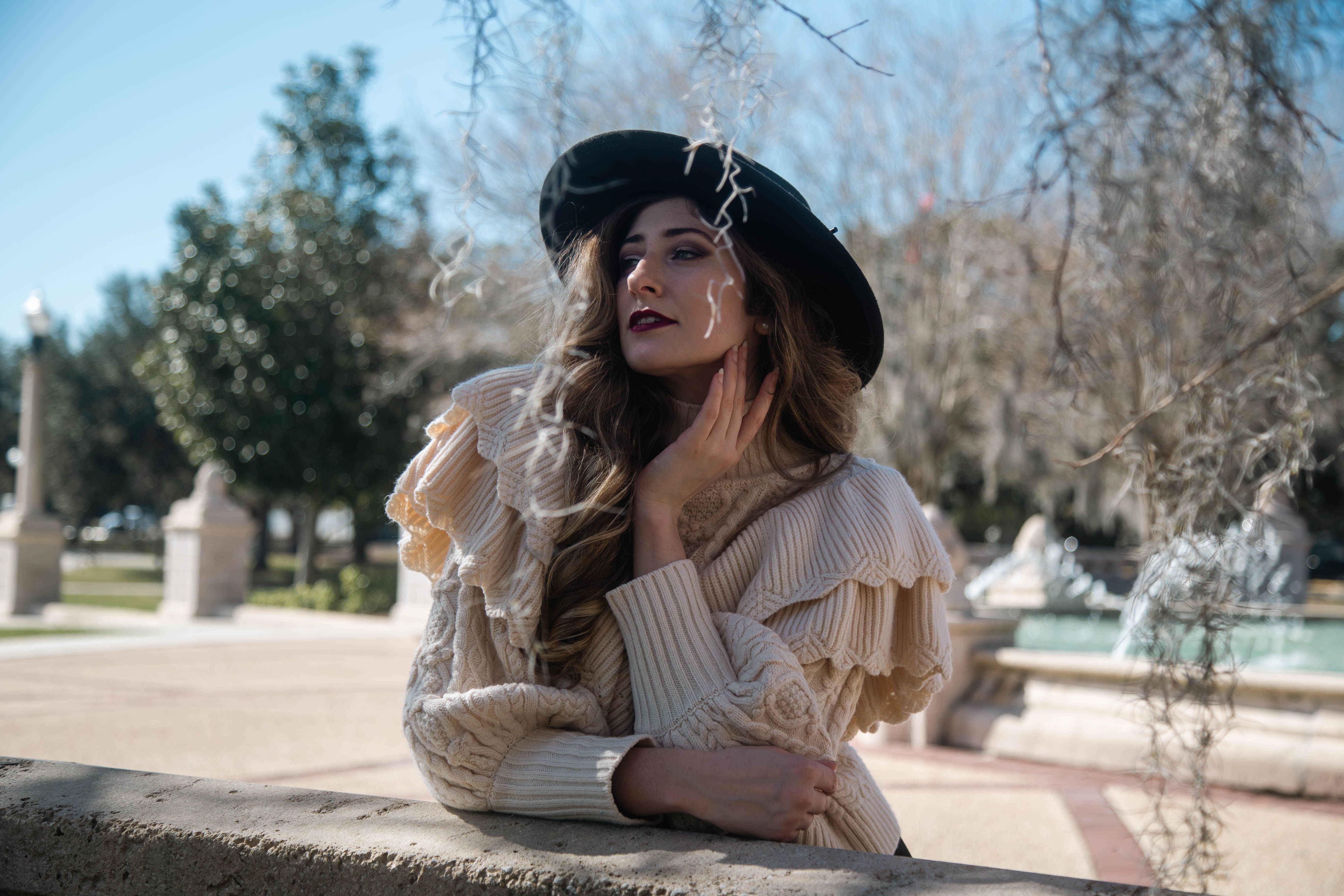 Woman with a Black Hat Looking Away while Posing · Free Stock Photo
