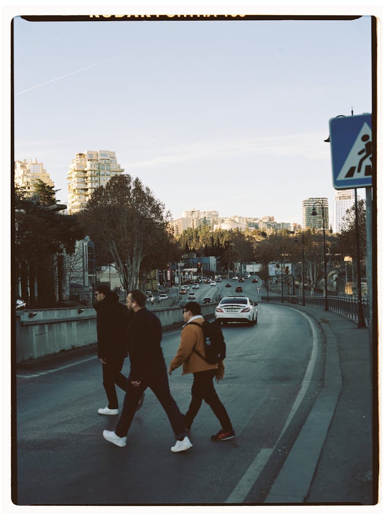 A Picture Of Men Crossing The Road