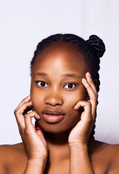 Beautiful portrait of a woman with braided hair on a white background.