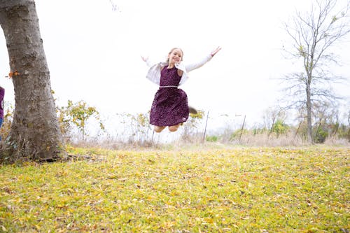 Free Girl Jumping on Grass Stock Photo